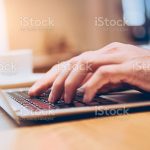 Hands of business person working on laptop